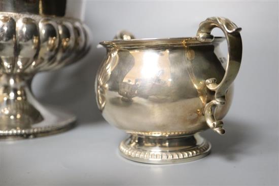 A silver milk jug and sugar bowl and a plated teapot and matching hot water jug,